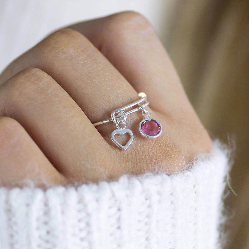 model wears  sterling silver adjustable birthstone charm ring with October Rose Swarovski crystal and dainty sterling silver charm