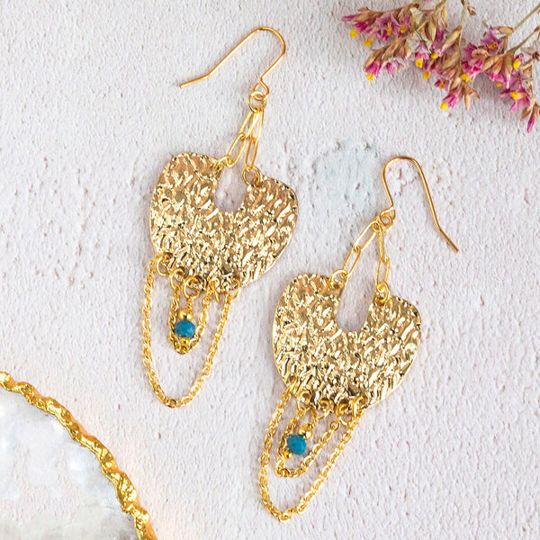 Image shows vega statement earrings with golden pave full moon, complete with chains and an indigo bead. Sat on a white backdrop.